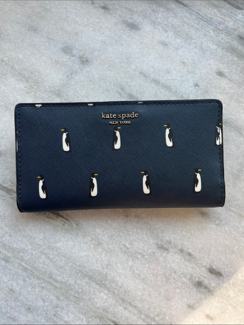 kate spade navy penguin print continental wallet with gold logo